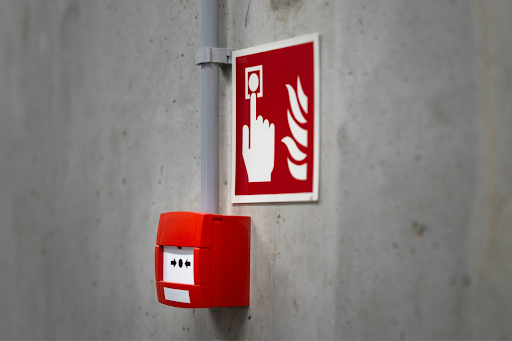 Industrial fire alarm system ready to be triggered, representing fire code requirements for lithium battery storage container areas